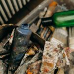A creative mess of used paint tubes and plastic bottles, capturing an artistic chaos.