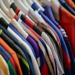 A bunch of shirts are hanging on a rack