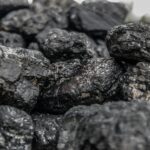 Detailed image of dark, textured coal pieces in a close-up view, highlighting their rugged surface.