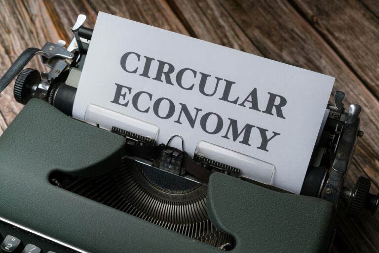 Close-up of a typewriter with 'Circular Economy' paper, suggesting sustainability.