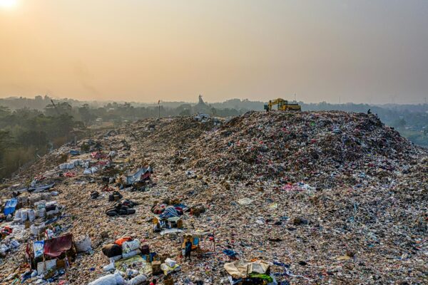 Aerial shot of a large landfill with garbage piles, showcasing waste management challenges.