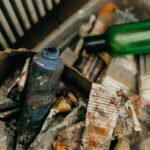 A creative mess of used paint tubes and plastic bottles, capturing an artistic chaos.