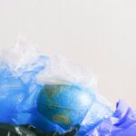 A globe surrounded by plastic bags, highlighting environmental pollution.