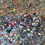 Aerial shot of a crowded landfill site with scattered trash in West Java, Indonesia.