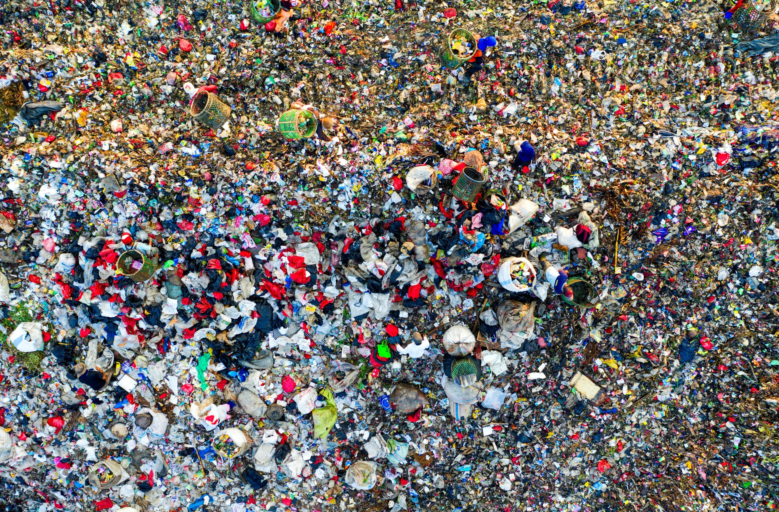Aerial shot of a crowded landfill site with scattered trash in West Java, Indonesia.