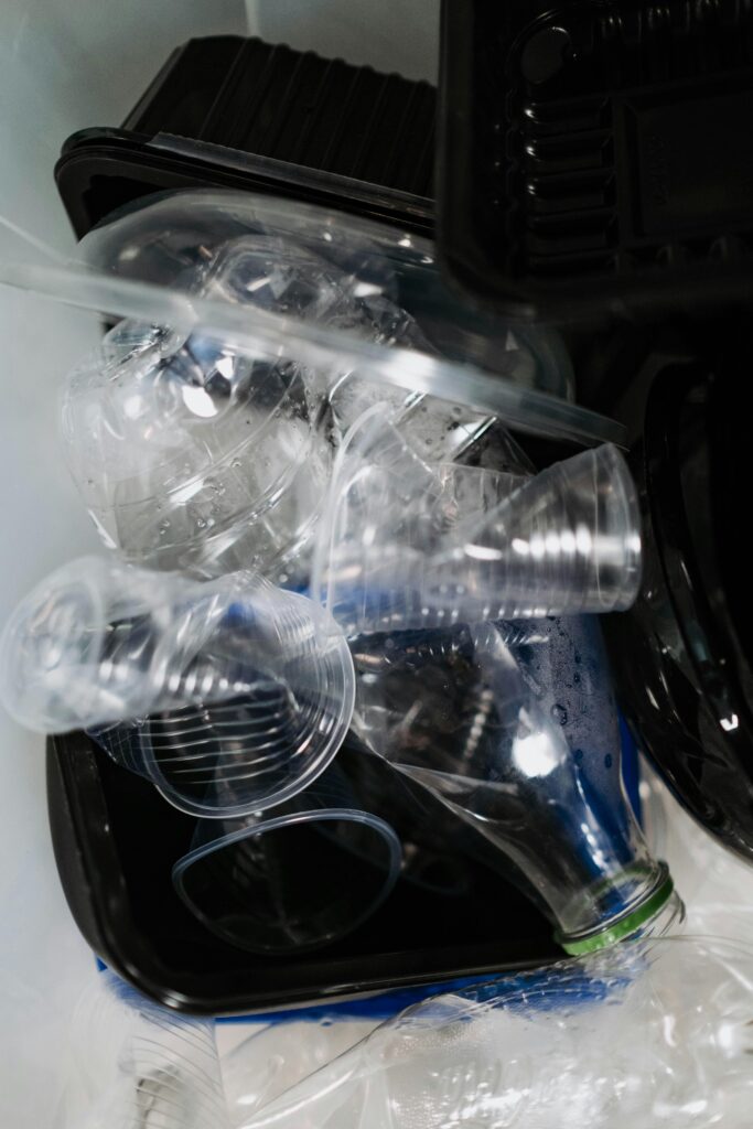Close-up of plastic waste in a recycling bin, highlighting environmental concerns.