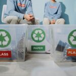 Volunteers organize recyclables into glass, paper, and plastic bins to promote eco-friendly practices.