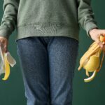 An adult holding organic waste and plastic, highlighting recycling and sustainability.