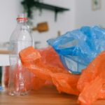 Assorted recycling materials on a kitchen counter, promoting sustainable living.