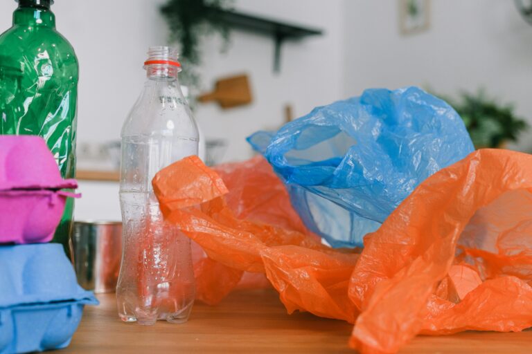 Assorted recycling materials on a kitchen counter, promoting sustainable living.