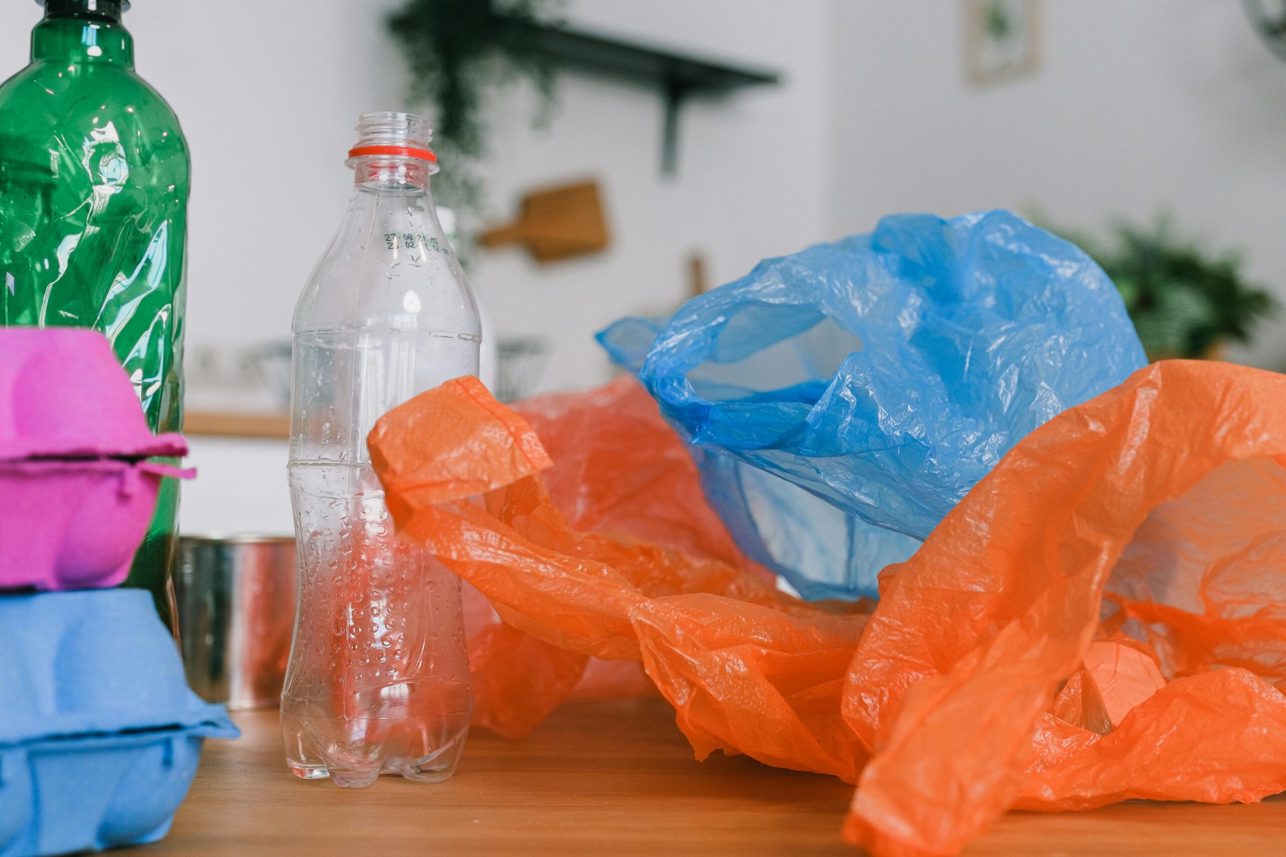 Assorted recycling materials on a kitchen counter, promoting sustainable living.