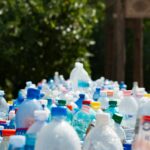 A vibrant collection of plastic bottles in an outdoor recycling setup, showcasing environmental awareness.