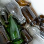 A collection of used glass bottles ready for recycling, promoting environment protection.