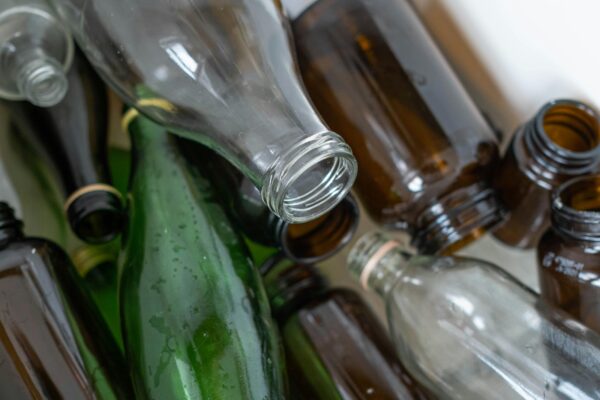 A collection of used glass bottles ready for recycling, promoting environment protection.