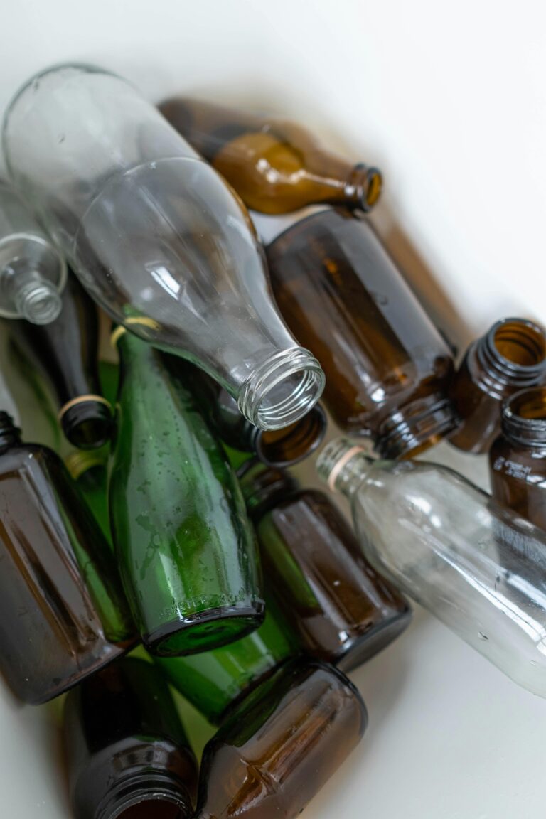 A collection of used glass bottles ready for recycling, promoting environment protection.