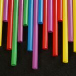 Multicolored plastic straws arranged in a vibrant, artistic pattern.